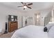 Spacious main bedroom featuring carpet, ceiling fan, and a view into the main bathroom at 6617 Johnny Love Ln, North Las Vegas, NV 89086