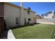A spacious backyard features lush artificial turf and a concrete block wall for added privacy at 6812 Sheffield Dr, Las Vegas, NV 89108