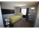Comfortable bedroom with a large window, wall mounted desk, and carpet flooring at 6812 Sheffield Dr, Las Vegas, NV 89108