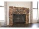 Stone fireplace creates a cozy focal point in the living area, complemented by natural light from nearby windows at 6812 Sheffield Dr, Las Vegas, NV 89108