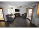 Comfortable living room with two sofas, a ceiling fan, and a view of the backyard at 6812 Sheffield Dr, Las Vegas, NV 89108