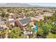 Expansive aerial view of a home with a pool and solar panels, nestled in a lush, vibrant neighborhood at 7301 Heggie Ave, Las Vegas, NV 89131