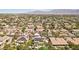 Expansive aerial shot of a desert neighborhood with palm trees and mountain views at 7301 Heggie Ave, Las Vegas, NV 89131