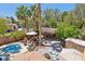 Backyard boasts a custom pool, cabana bar, patio seating, and lush landscaping at 7301 Heggie Ave, Las Vegas, NV 89131