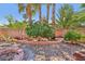 Backyard featuring a charming garden, mature trees, and privacy wall at 7301 Heggie Ave, Las Vegas, NV 89131
