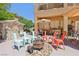 A backyard with ample seating surrounding a unique fire pit feature at 7301 Heggie Ave, Las Vegas, NV 89131