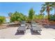 Landscaped backyard with lounge chairs, a small garden and shade trees perfect for outdoor relaxation at 7301 Heggie Ave, Las Vegas, NV 89131