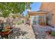 Charming backyard features decorative artwork, quaint decor, desert landscaping and ample room for relaxation at 7301 Heggie Ave, Las Vegas, NV 89131