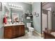 Traditional bathroom features a wood vanity, marble tile flooring, and shower with glass door at 7301 Heggie Ave, Las Vegas, NV 89131