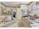 Bright bathroom boasts a glass shower and an oversized tub with large windows at 7301 Heggie Ave, Las Vegas, NV 89131