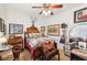 Bright bedroom offers a bed, ceiling fan, window, and unique western-themed decorations at 7301 Heggie Ave, Las Vegas, NV 89131