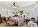 Cozy bedroom boasts abundant natural light, complemented by charming decor and a ceiling fan at 7301 Heggie Ave, Las Vegas, NV 89131