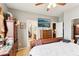 Bedroom with a ceiling fan, light walls, and dark wood furnishings with access to a bathroom at 7301 Heggie Ave, Las Vegas, NV 89131