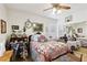 A well-lit bedroom features a comfortable quilt bed, ceiling fan and vintage decorations at 7301 Heggie Ave, Las Vegas, NV 89131