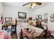 Charming bedroom featuring a wrought iron bed frame, ceiling fan and a variety of decor displayed throughout the room at 7301 Heggie Ave, Las Vegas, NV 89131