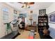 Bedroom featuring a large window, ceiling fan, mounted television, and a variety of sports memorabilia on display at 7301 Heggie Ave, Las Vegas, NV 89131
