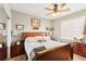 A bedroom featuring neutral walls, a light ceiling fan, and a dark wood furnishings at 7301 Heggie Ave, Las Vegas, NV 89131