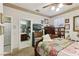 Bedroom with a traditional bed frame, an adjacent bathroom, and a television mounted on the wall at 7301 Heggie Ave, Las Vegas, NV 89131