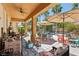 Relaxing covered patio with comfortable seating overlooking the pool and landscaped yard at 7301 Heggie Ave, Las Vegas, NV 89131