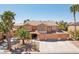 Desirable home featuring a three car garage, immaculate landscaping, and tall mature palm trees at 7301 Heggie Ave, Las Vegas, NV 89131