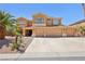Stunning two-story home with a three-car garage and desert landscaping at 7301 Heggie Ave, Las Vegas, NV 89131
