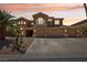 Inviting two-story home with a three-car garage, desert landscaping, and a charming balcony at 7301 Heggie Ave, Las Vegas, NV 89131