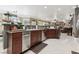 Open kitchen area with tile floors, an extended breakfast bar, and modern appliances at 7301 Heggie Ave, Las Vegas, NV 89131