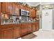 Kitchen featuring granite countertops, stainless steel microwave, and cherry wood cabinets at 7301 Heggie Ave, Las Vegas, NV 89131