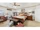 Comfortable main bedroom with a ceiling fan, carpet, and French doors to the backyard at 7301 Heggie Ave, Las Vegas, NV 89131