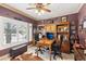 Home office with a large window, decorative shelving, and a wooden desk with leather chairs and unique decorations at 7301 Heggie Ave, Las Vegas, NV 89131