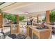 Well-equipped outdoor kitchen featuring stainless steel appliances, a built-in grill, and ample counter space at 7301 Heggie Ave, Las Vegas, NV 89131