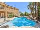Beautiful pool with rock features, palm trees, and a spacious patio area at 7301 Heggie Ave, Las Vegas, NV 89131