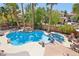 Private backyard oasis with a custom pool, rock waterfall, and lush landscaping at 7301 Heggie Ave, Las Vegas, NV 89131