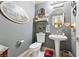 Rustic powder room featuring western decor, white toilet and pedestal sink, and decorative mirror and lighting fixture at 7301 Heggie Ave, Las Vegas, NV 89131
