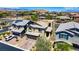 Beautiful aerial view of a two-story home featuring solar panels, lush landscaping, and a paver driveway at 7322 Columbia Rock Ct, Las Vegas, NV 89178