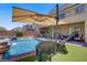 Lush backyard with a sparkling pool, spa, and outdoor seating area, perfect for entertaining guests at 7322 Columbia Rock Ct, Las Vegas, NV 89178