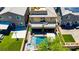Aerial view of a backyard featuring a pool with waterfall, outdoor seating, basketball hoop, and low-maintenance artificial turf at 7322 Columbia Rock Ct, Las Vegas, NV 89178