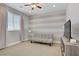 Bright bedroom with a ceiling fan, light-colored walls, and a comfortable sitting area at 7322 Columbia Rock Ct, Las Vegas, NV 89178