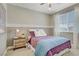 Bedroom with two-tone walls, soft carpet, and a comfortable bed with decorative pillows at 7322 Columbia Rock Ct, Las Vegas, NV 89178
