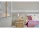Bedroom with a lamp on a wooden nightstand and decorative artwork at 7322 Columbia Rock Ct, Las Vegas, NV 89178