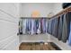 Walk-in closet features wood floor, multiple shelves, hanging rods, and ample storage space at 7322 Columbia Rock Ct, Las Vegas, NV 89178