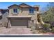 Charming two-story home with a well-manicured front yard, paver driveway, and attached two-car garage at 7322 Columbia Rock Ct, Las Vegas, NV 89178