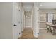 Hallway with wood flooring and view into an office with gray walls and carpet at 7322 Columbia Rock Ct, Las Vegas, NV 89178