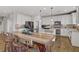 Bright eat-in kitchen features white cabinetry, stainless steel appliances, granite countertops and hardwood floors at 7322 Columbia Rock Ct, Las Vegas, NV 89178