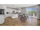 Bright kitchen features white cabinetry, stainless steel appliances, breakfast nook, and a sliding door to the patio at 7322 Columbia Rock Ct, Las Vegas, NV 89178