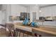 Bright kitchen features white cabinetry, stainless steel appliances, granite countertops and hardwood floors at 7322 Columbia Rock Ct, Las Vegas, NV 89178