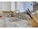 Close up on kitchen sink, granite countertops, modern faucet and backsplash at 7322 Columbia Rock Ct, Las Vegas, NV 89178