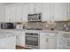 Well-equipped kitchen featuring stainless steel appliances, granite counters, and white cabinets at 7322 Columbia Rock Ct, Las Vegas, NV 89178