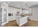 Bright kitchen features white cabinetry, stainless steel appliances, granite countertops and hardwood floors at 7322 Columbia Rock Ct, Las Vegas, NV 89178