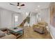 Inviting living room features wood floors, a ceiling fan, and a staircase at 7322 Columbia Rock Ct, Las Vegas, NV 89178